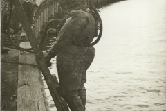 A diver ready to go down in the harbour .  Photo from "The Peter Burch Collection".